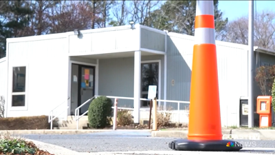 An orange cone in front of the post office.
