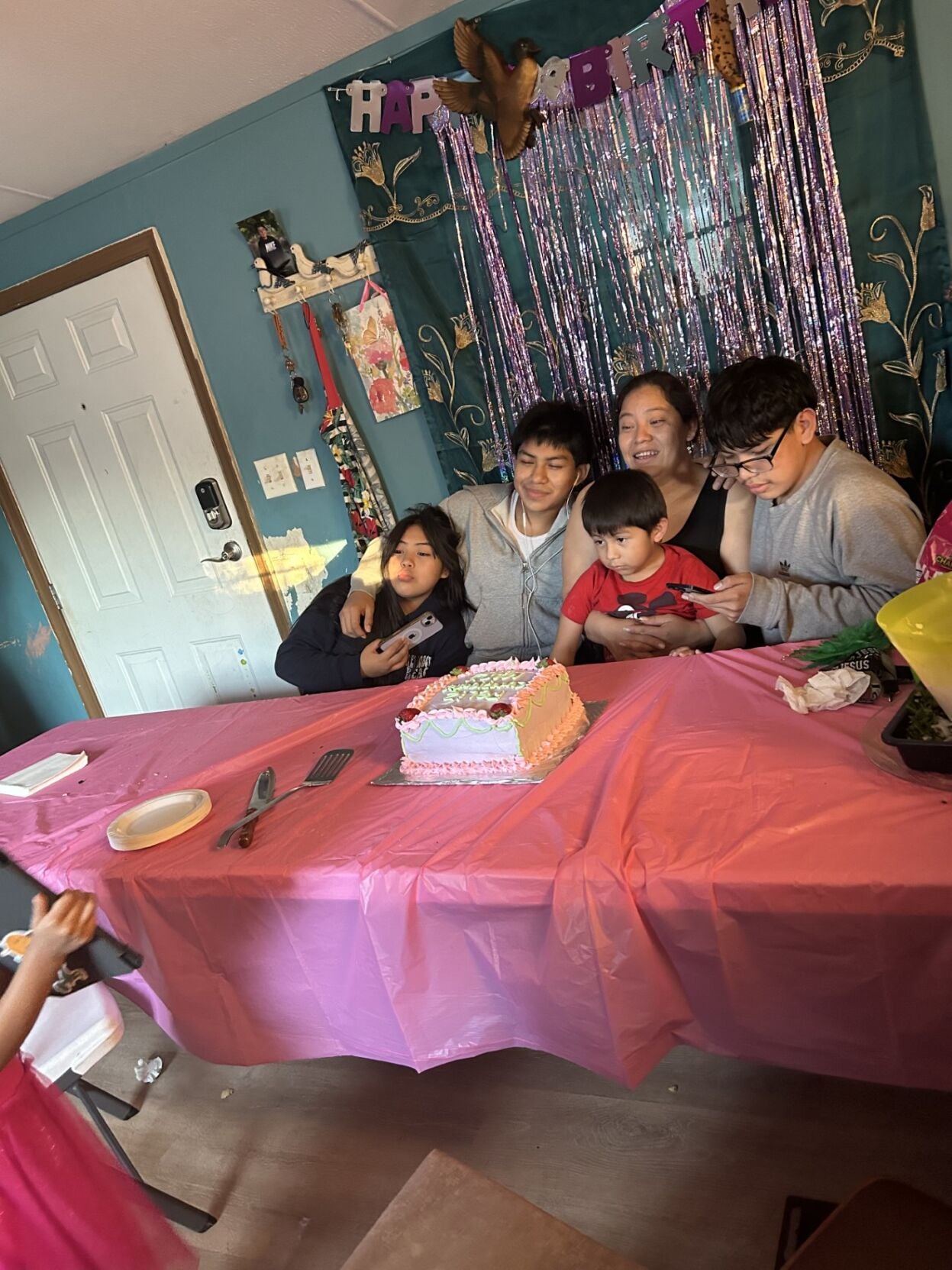 Family members gather around Soto at a party.
