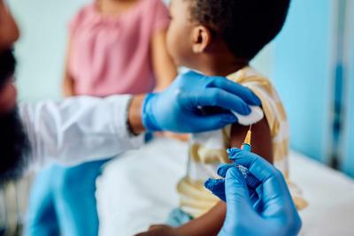 A child receiving a shot from a doctor.