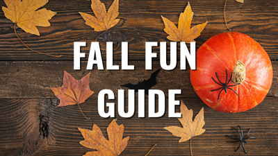 "Fall Fun Guide" over a wooden table with leaves and a pumpkin.