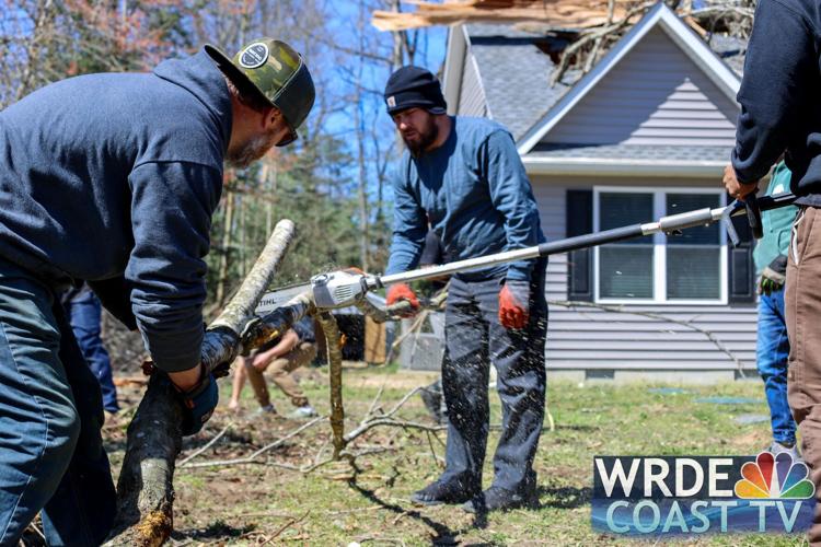 Volunteers working to cut up debris on Sunday.