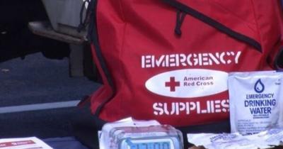 An image showing an emergency preparedness kit with a packet of emergency drinking water sitting on the outside of the bag.