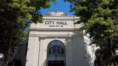 A picture of the Ocean City City hall with the sun hitting the sign on the building.