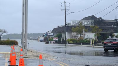 Standing water floods a road in Dewey Beach near the Rusty Rudder restaurant. 