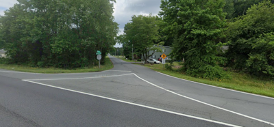 A road with several trees.