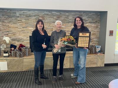 Karen Fischer (center) receives the 2022 Lewes Public Library Volunteer of the Year Award from volunteer coordinator Tracy Dietz (left) and director Lea Rosell (right). Courtesy Lewes Public Library.