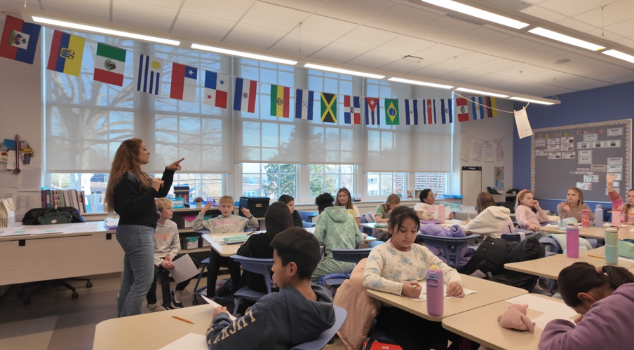 Students can be heard practicing Spanish phrases and singing along.