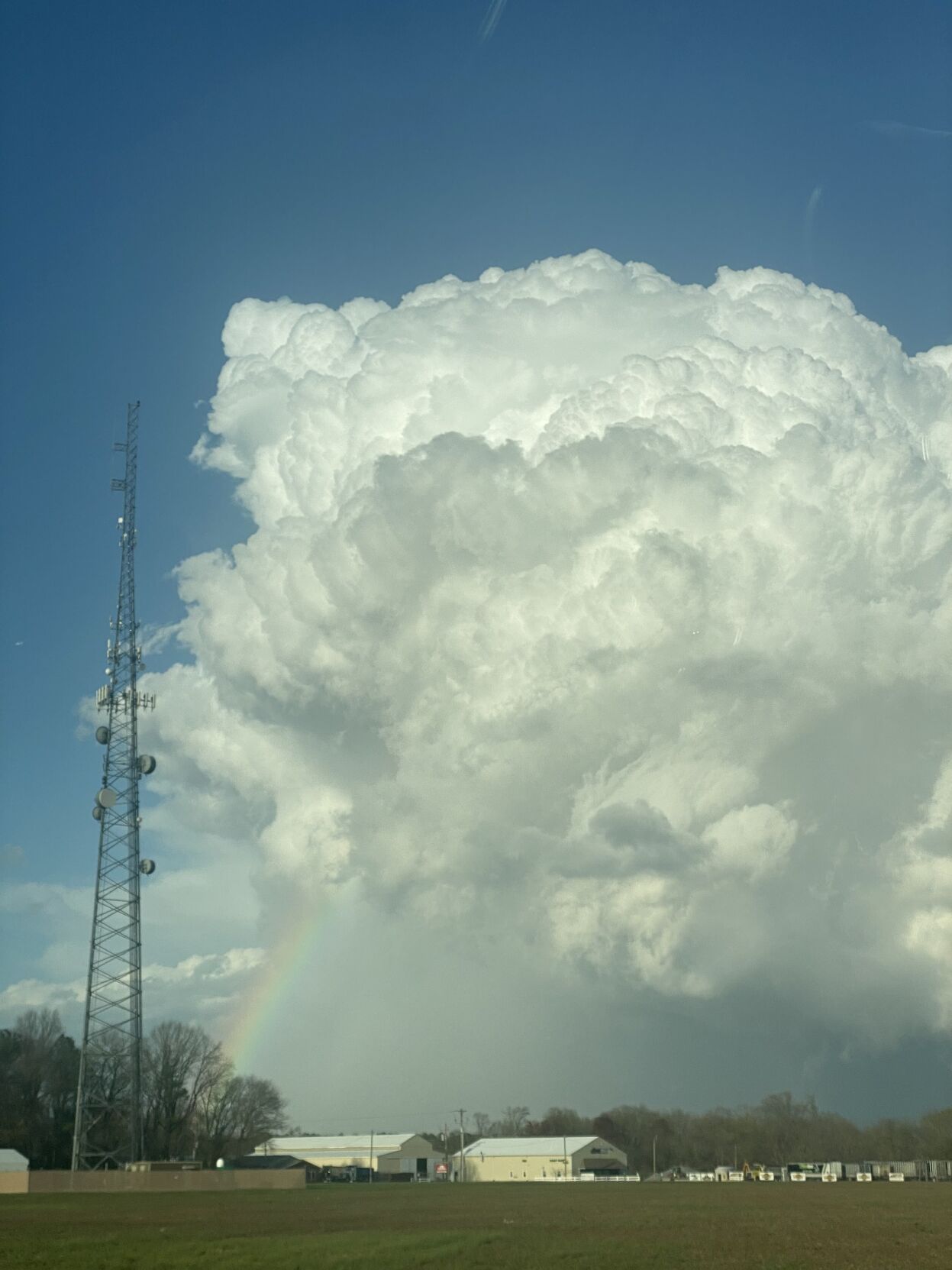 A rainbow can be seen near a large cloud Saturday afternoon in Bridgeville.