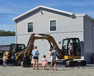 Kids and their parents looking at landscaping equipment. 