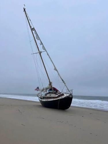 A sailboat on the sand.