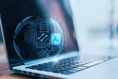 A close up of a laptop with a blue graphic that says "AI".