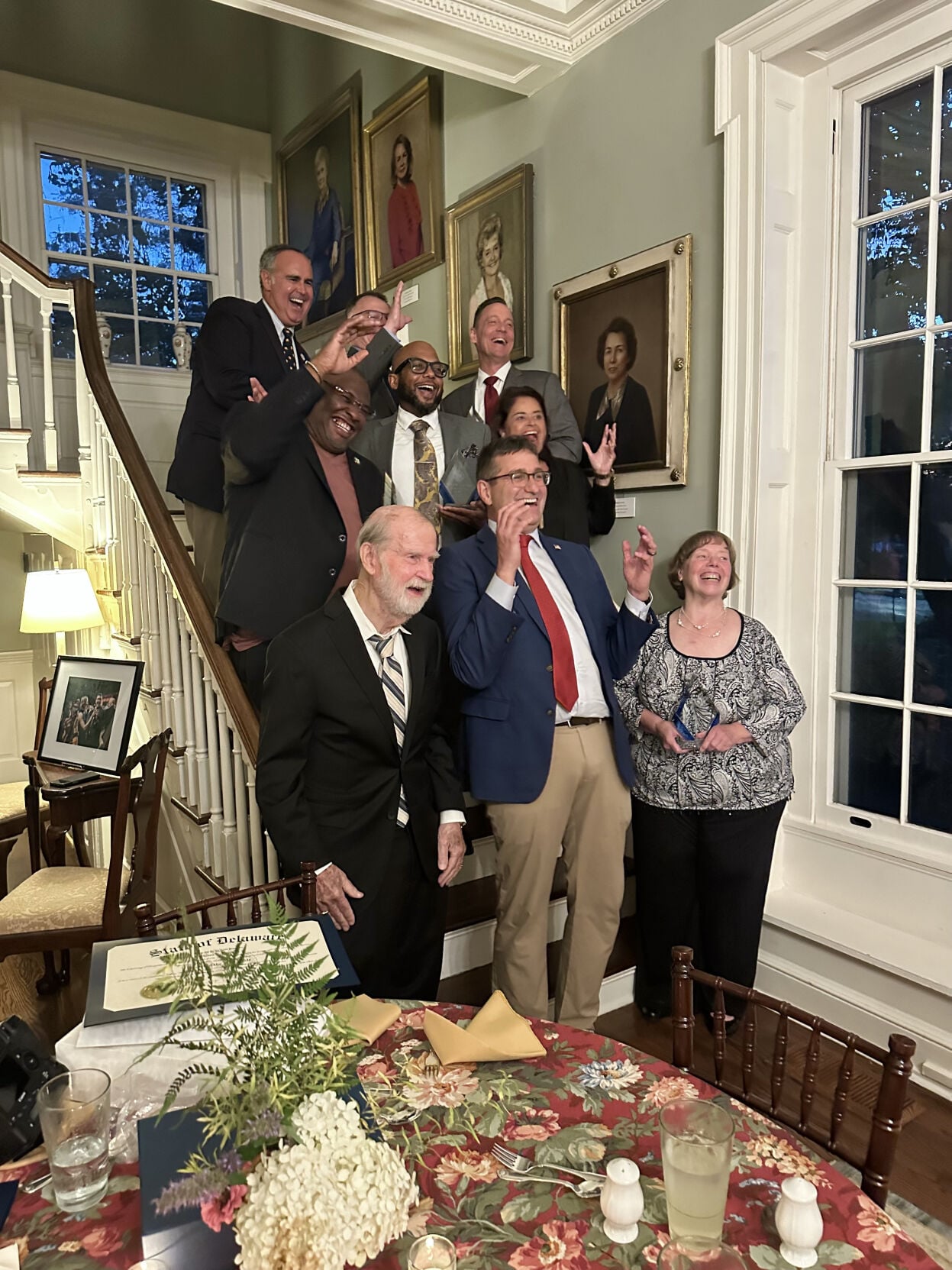 Eight people standing on a stairwell