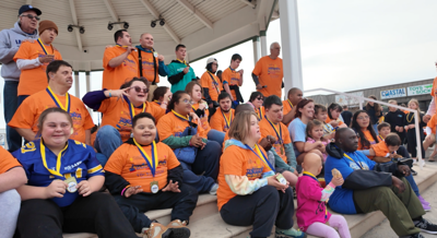 Walk participants posing with their metals. 