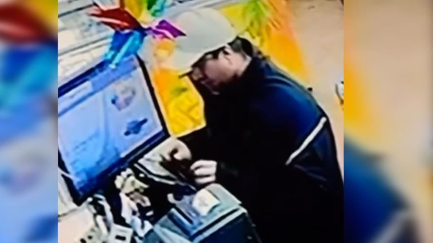 A man police say is a suspect in the El Mercado Market skimming device scam in Georgetown, placing the skimming device on the credit card terminal