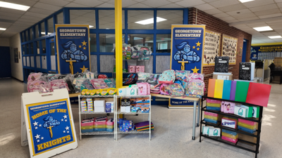 School supplies sit on carts in a school lobby.