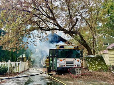 Smoke pouring out of the trailer with firemen responding