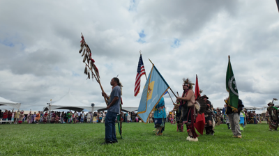Members of the Nanticoke Indian Tribe holding flags during a ceremony.