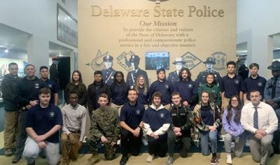 Delaware State Police troopers standing with past participants of The Trooper Youth Program. Courtesy Delaware State Police.