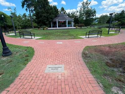A brick walkway going around a gazebo.