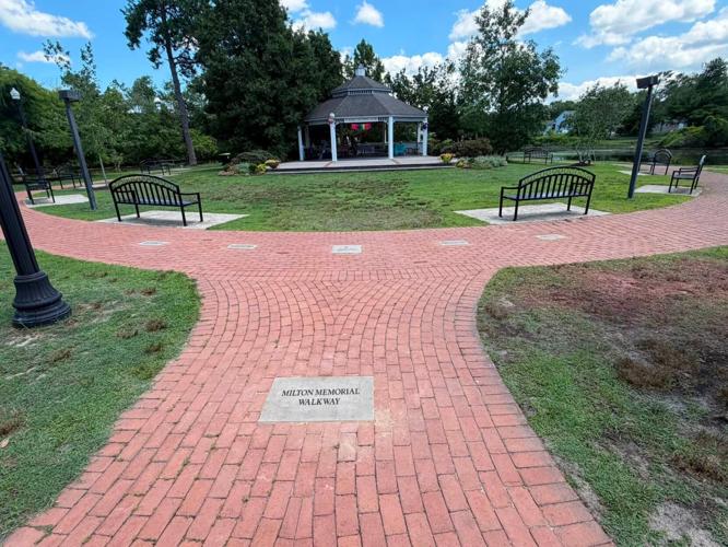 A brick walkway going around a gazebo.