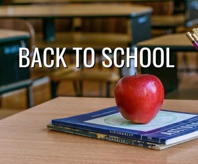 "Back to School" text on top of school desks, an apple, and books on a desk.
