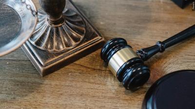 A gavel rests on top of a table.