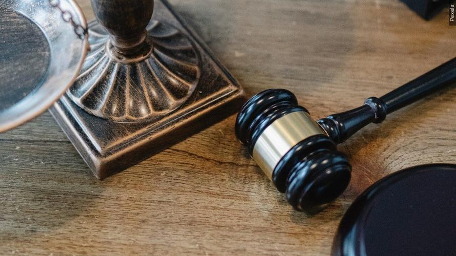 A gavel rests on top of a table.