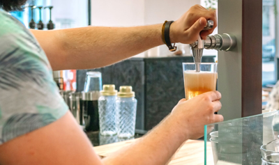 Beer poured into a glass from a tap. Eight pieces of legislation recently passed in the Delaware General Assembly impacting alcoholic beverage regulation.