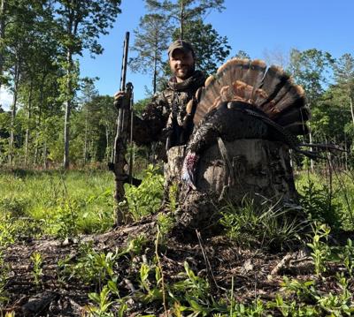 Wldlife biologist with bagged gobbler on public land