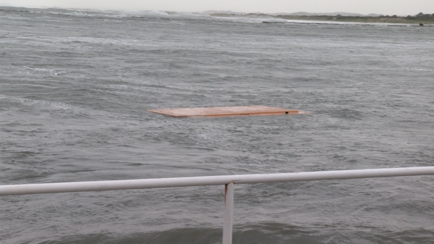 A piece of flooring floating in the ocean.