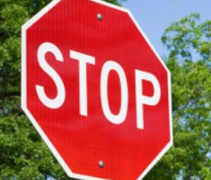 A stop with red background and white lettering.