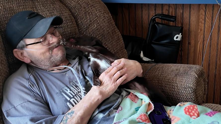 Samuel Oakley and his cat, Luna. Oakley receives pet food donations from CHEER in Georgetown.
