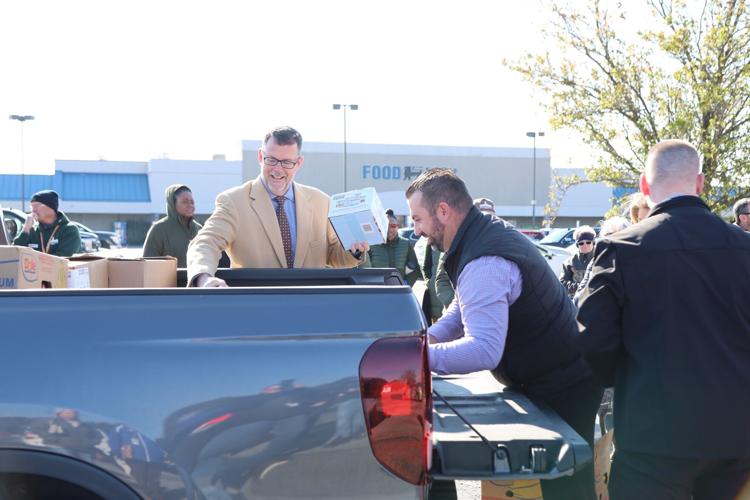 Food Lion's Director of Operations Alan Philips (center) helps to load a truck with food as part of the first food rescue using the 302 Food Rescue app in Delaware