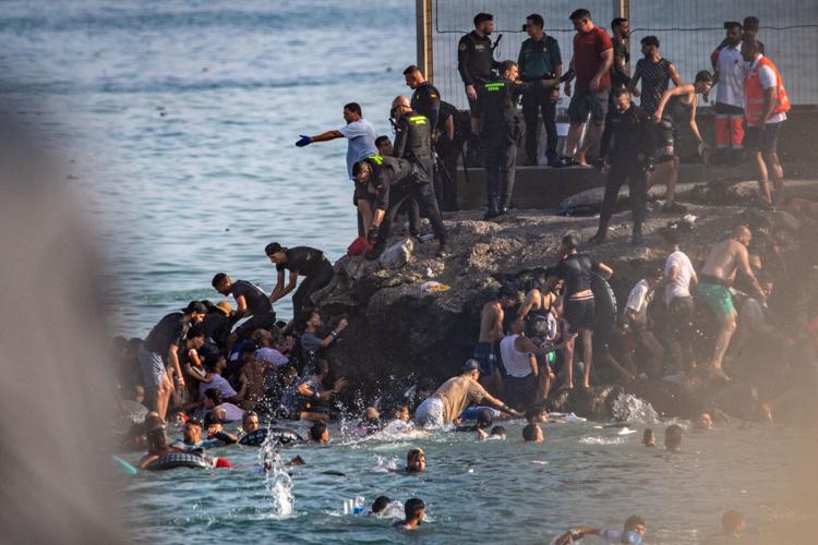 Migrants cross into Spain’s Ceuta enclave from Morocco, in photos