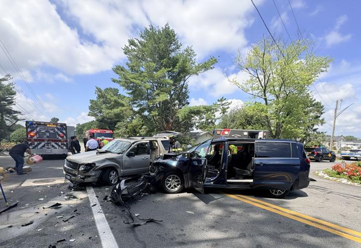 Two cars crashed into each other on a roadway.