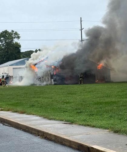 Smoke pouring out of the building as crews begin to fight the fire.