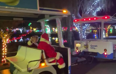 santa clause sits in a light show 