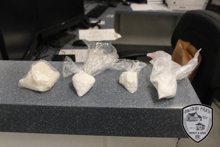 Four plastic bags of a white powder-like drug sit on a counter.
