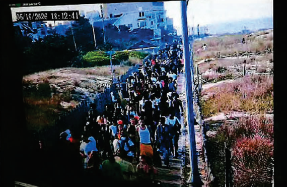 People crowd the Rehoboth Beach boardwalk.