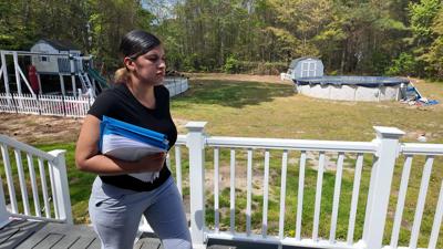 Tammy Johnson holds the complaint and school referrals she submitted to the state.