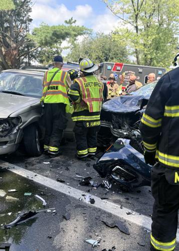 Two cars crashed into each other on a roadway.