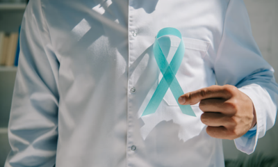 man holds teal ribbon 