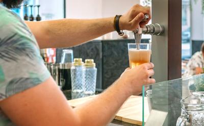 Someone pouring Beer from a Tap