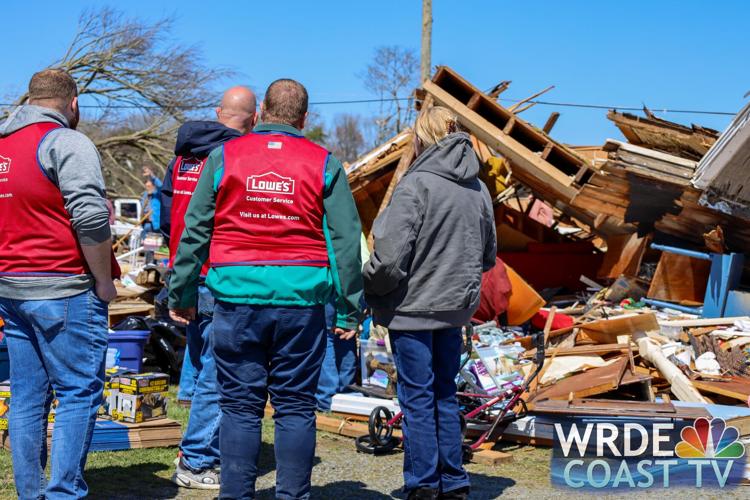 Belongings can be seen in front of a destroyed home.