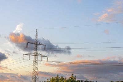 Power grid at sunset. Infrastructure and energy. Nature technology
