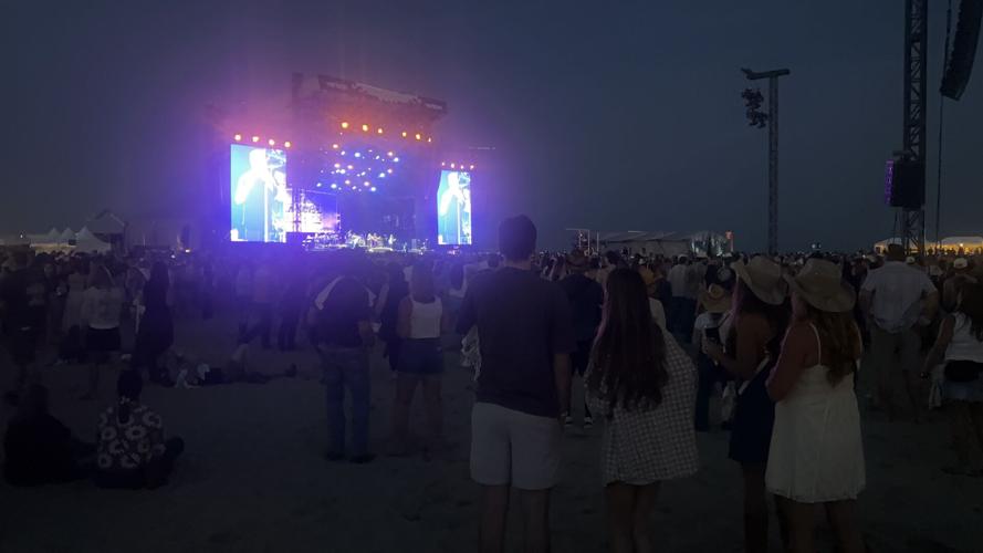 A crowd gathers at the Boot Stage at night.