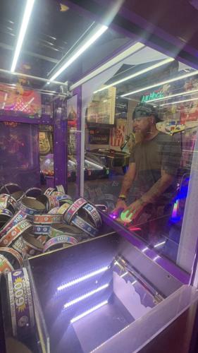 A man playing a crane machine.