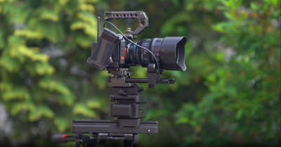 A film camera with trees in the background.