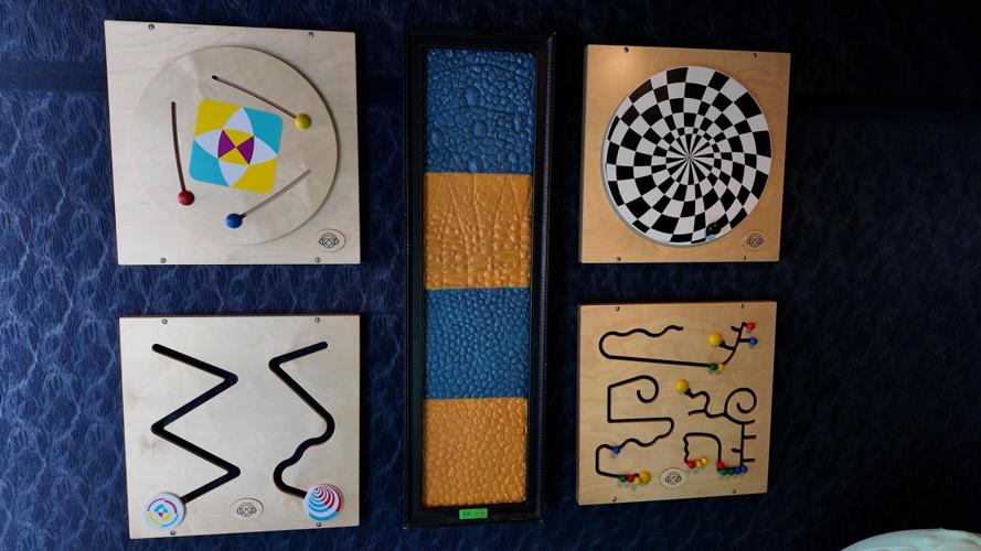 Fidget toys on the wall inside of the sensory activation vehicle at the Delaware State Fair