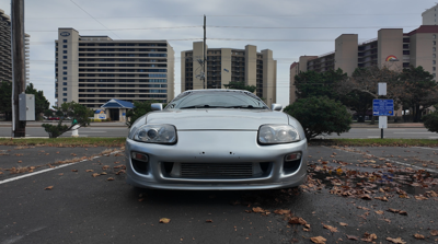 1995 Toyota Supra sitting in a parking lot.